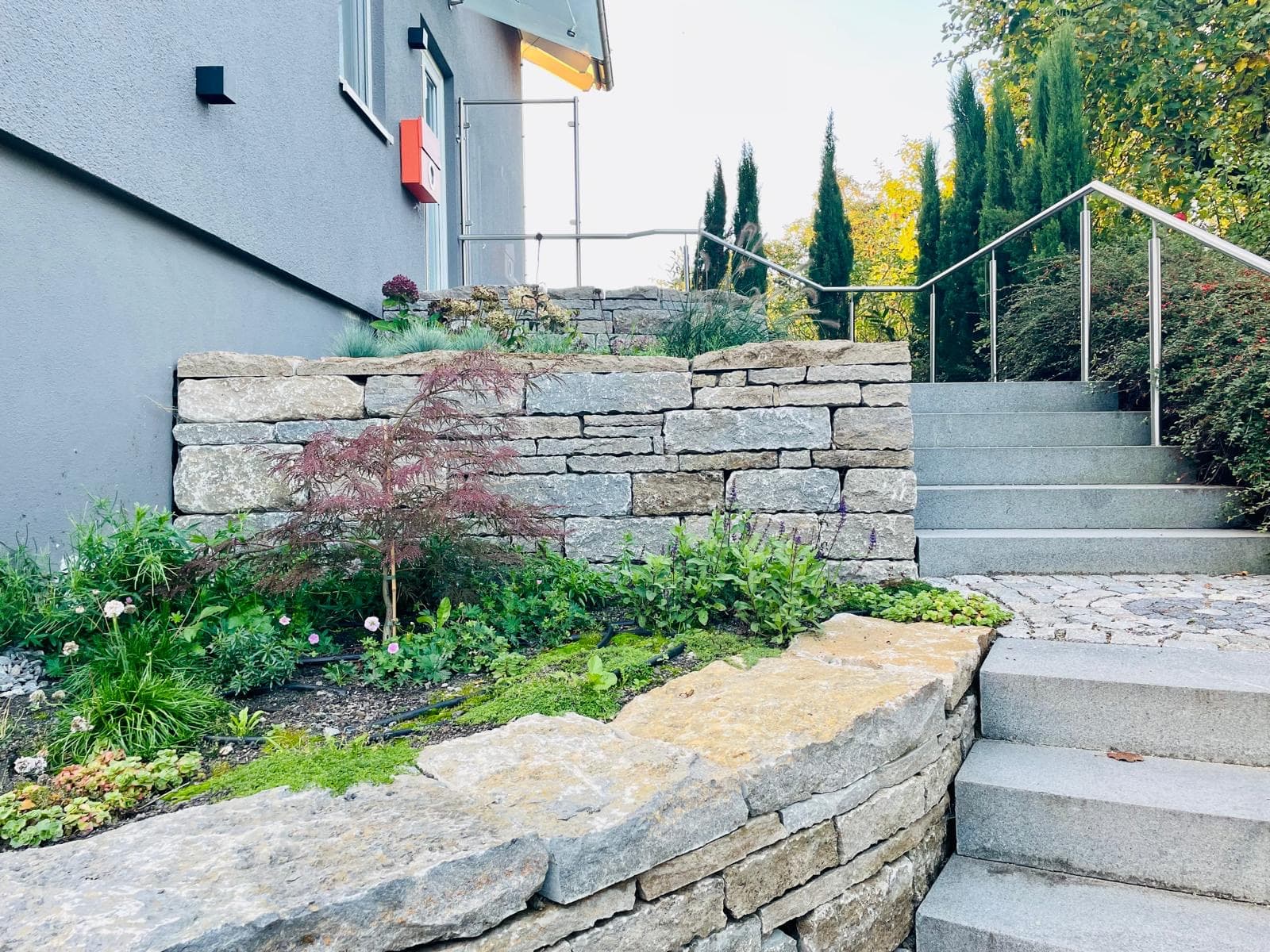 A patio with large stone tiles and outdoor furniture